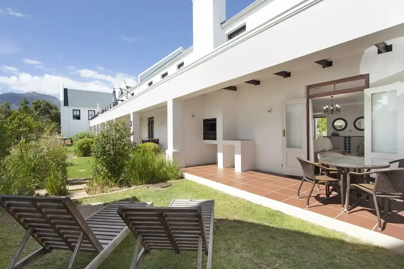 Lodge 16 outdoor patio with built-in braai with garden views