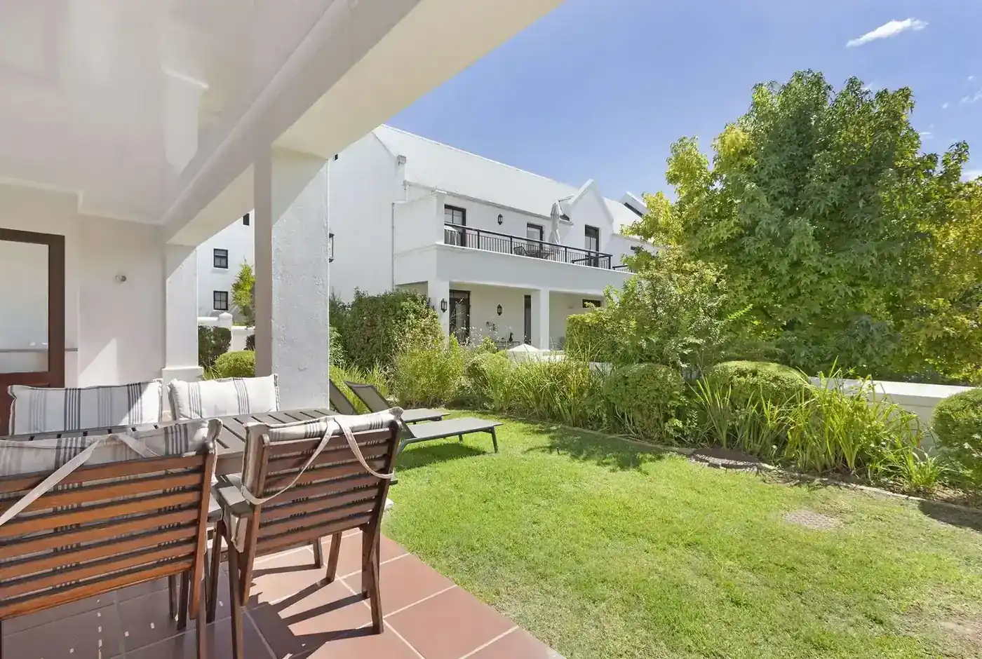 Lodge 17 outdoor patio with built-in braai with garden views