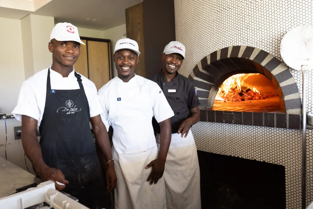 Chefs at the wood-fired pizza oven