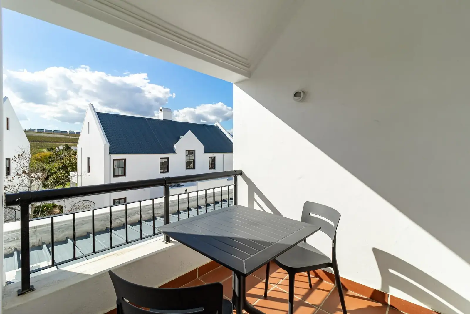 Lodge 15 outdoor patio with built-in braai with garden views