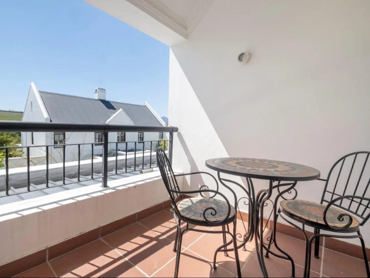Lodge 13 outdoor patio with built-in braai with garden views