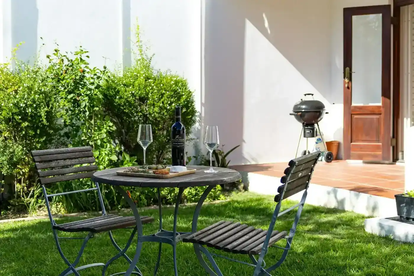 Lodge 19 outdoor patio with built-in braai with garden views
