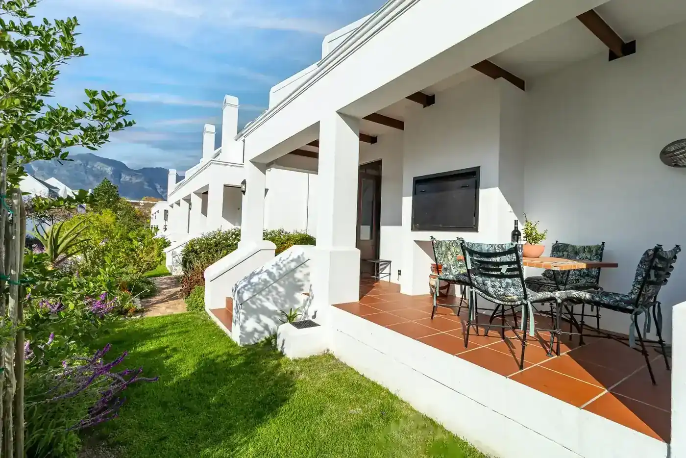 Lodge 14 outdoor patio with built-in braai with garden views